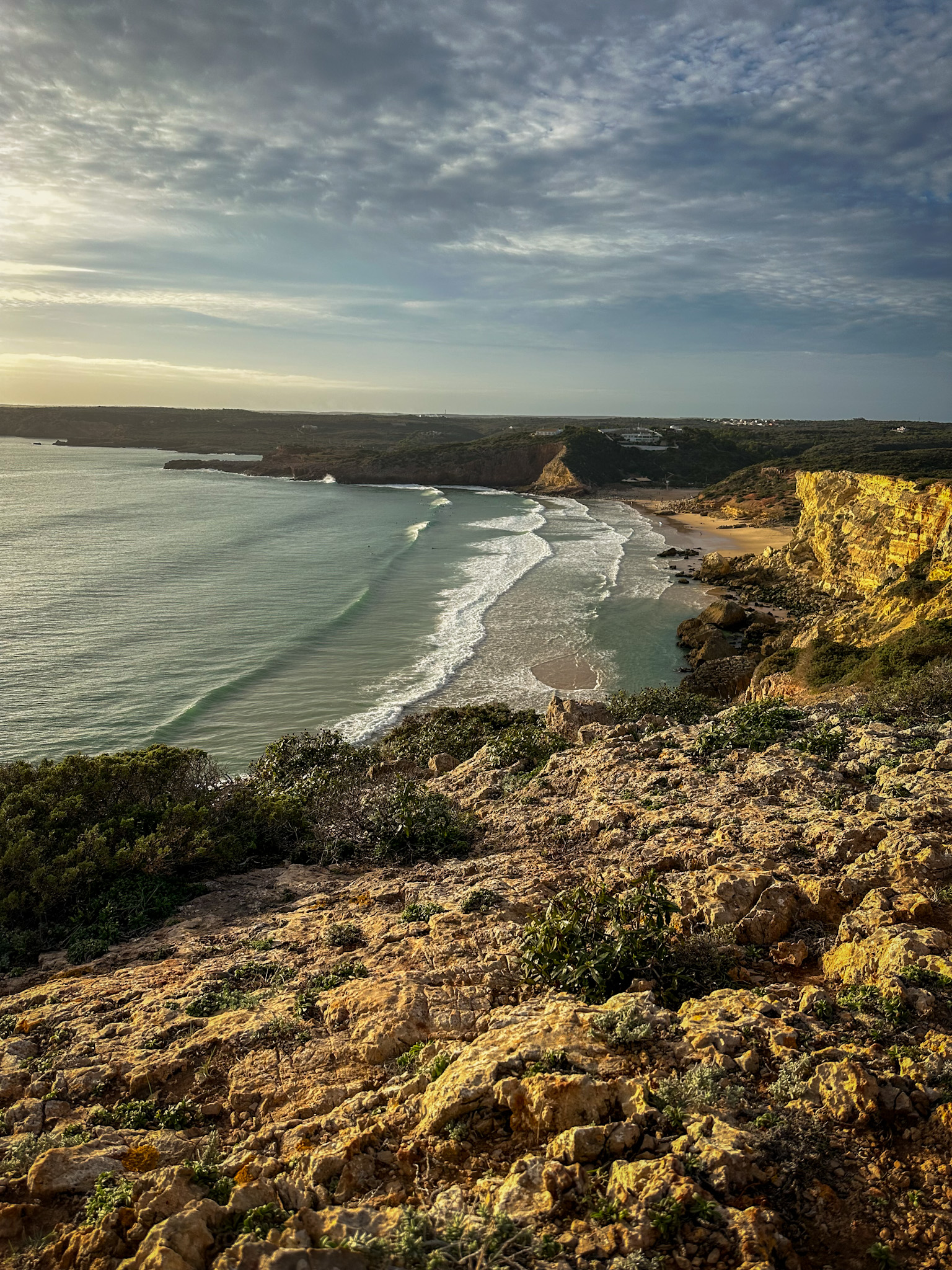 praia do zavial with surfers in the distance