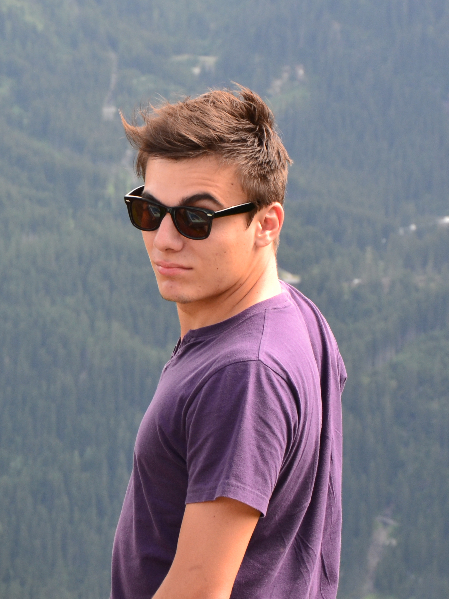 silviu wearing sunglasses on the edge of a cliff in the bavarian alps